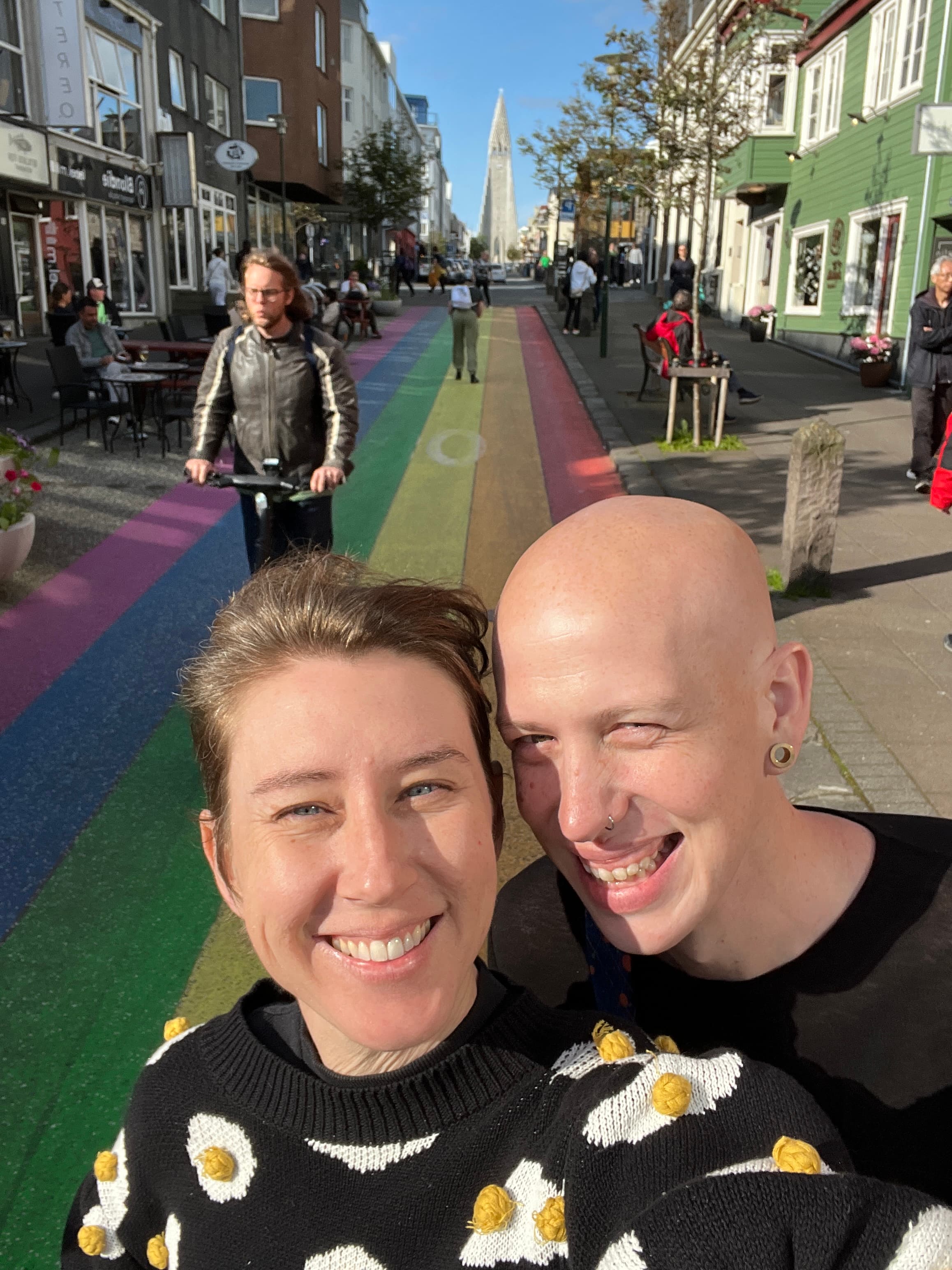 Andrea and Elli on rainbow road - representing our philosophy of inclusivity and joy